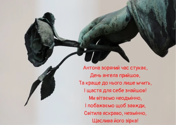 Бронзова рука тримає зів'ялу троянду та вірш про Антона.